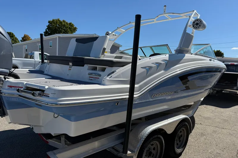 Slide: The Image of 2024 Chaparral 23 SSi OB boat on trailer, sleek design, outdoor setting. - 23