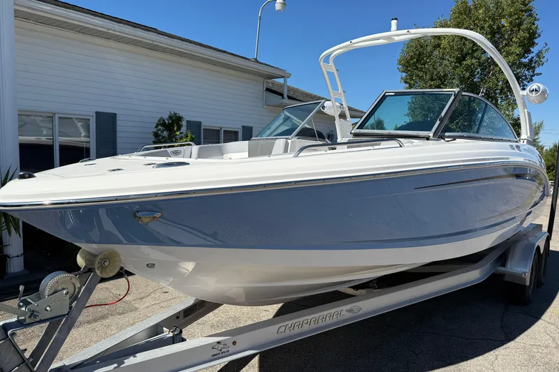 Slide: The Image of 2024 Chaparral 23 SSi OB boat on trailer, parked outdoors. - 27