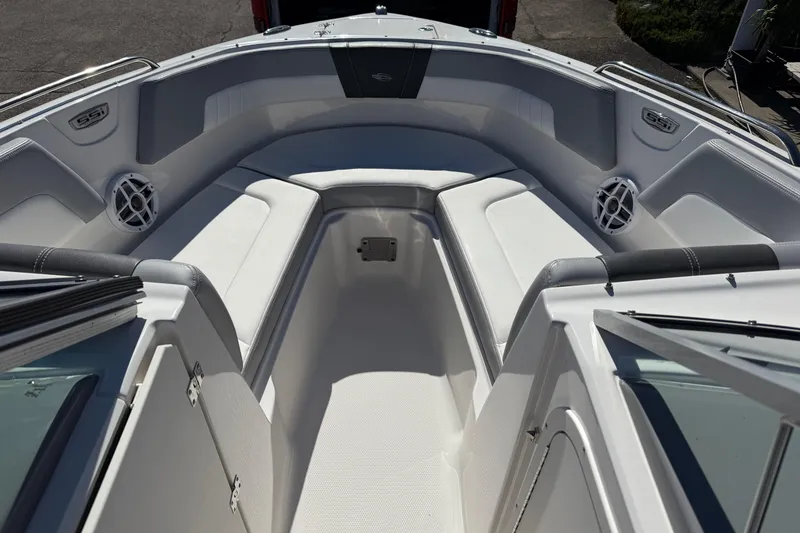 Slide: The Image of 2024 Chaparral 23 SSi OB boat interior with white seating and speakers. - 5