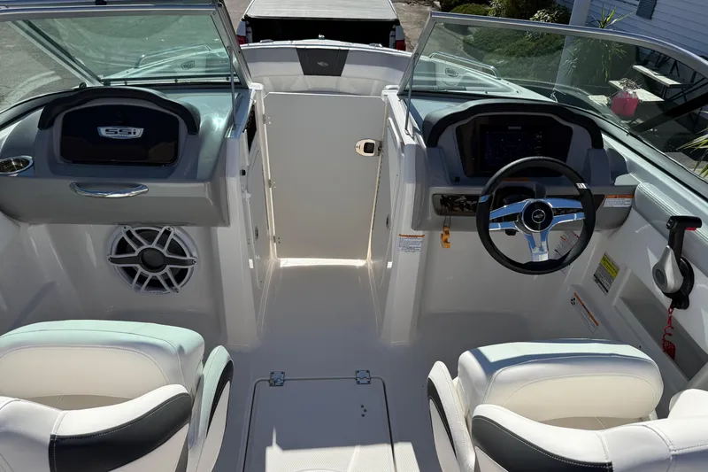 Slide: The Image of 2024 Chaparral 23 SSi OB boat interior with steering wheel and seating. - 9