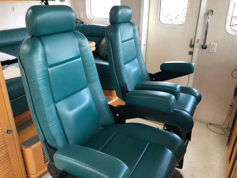 Slide: The Image of Luxurious teal seating inside a 2003 Cape Horn Trawler yacht cabin. - 17