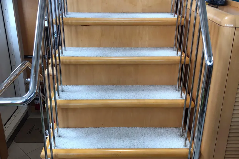 Slide: The Image of Staircase with wooden steps and metal railings inside a 2003 Cape Horn Trawler. - 18