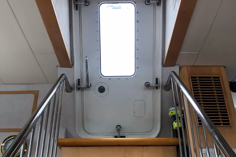Slide: The Image of Staircase leading to a door inside a 2003 Cape Horn Trawler boat. - 19