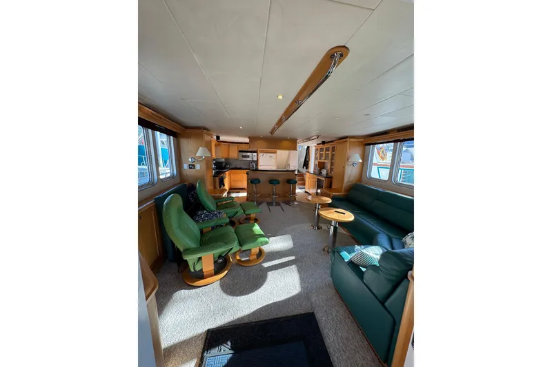 Slide: The Image of Luxurious interior of 2003 Cape Horn Trawler with green seating and modern kitchen. - 2