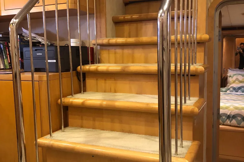 Slide: The Image of Interior stairs of a 2003 Cape Horn Trawler with wooden steps and metal railings. - 23