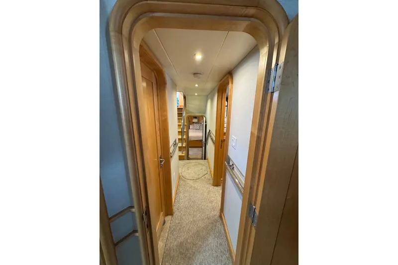 Slide: The Image of Interior hallway of 2003 Cape Horn Trawler with wooden doors and carpeted floor. - 25