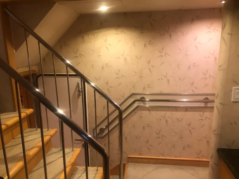Slide: The Image of Staircase with metal railing inside 2003 Cape Horn Trawler, featuring patterned wallpaper. - 26