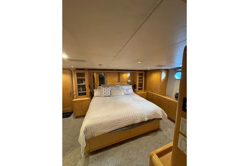 Slide: The Image of Luxurious bedroom interior of 2003 Cape Horn Trawler with cozy bed and wooden cabinetry. - 29