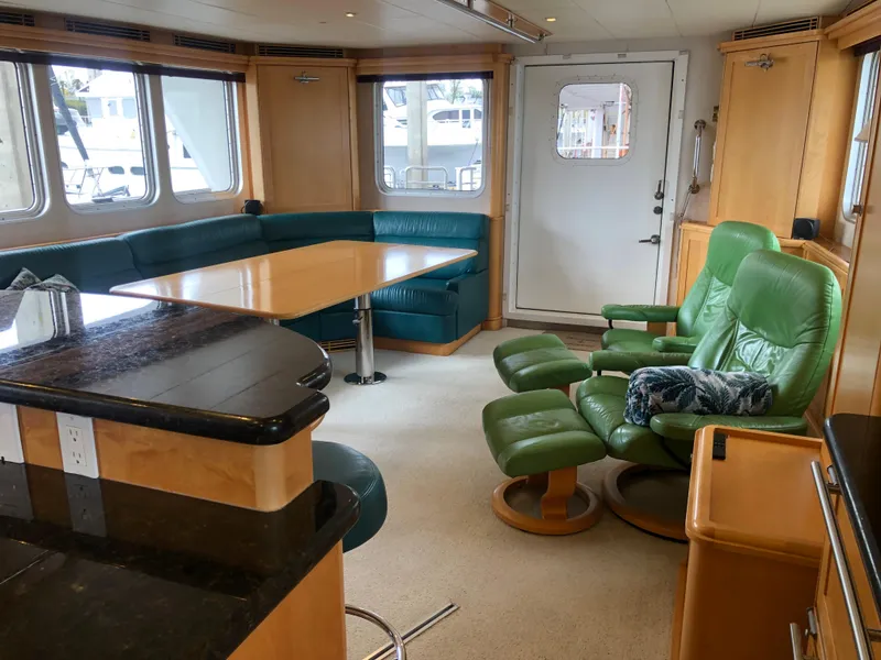 Slide: The Image of Interior of 2003 Cape Horn Trawler with green seating and wooden accents. - 3
