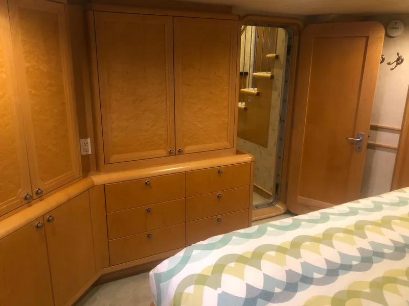 Slide: The Image of Interior of 2003 Cape Horn Trawler with wooden cabinets and patterned bedspread. - 30