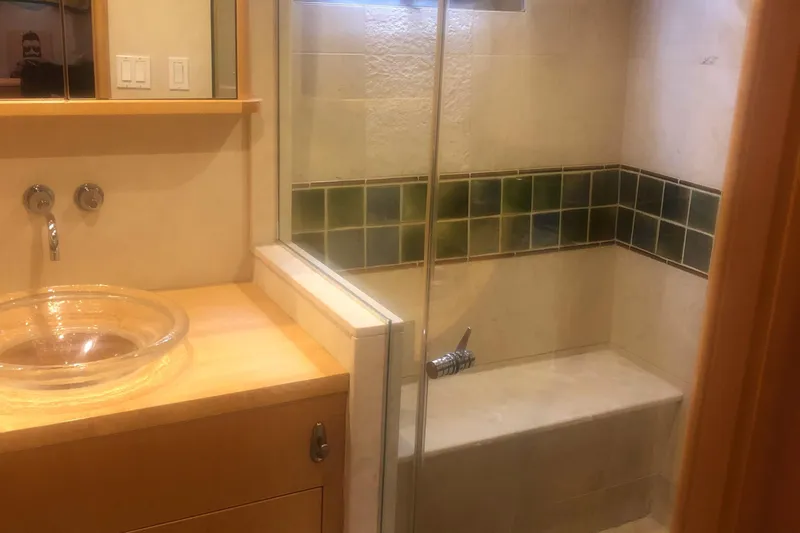 Slide: The Image of Bathroom interior of 2003 Cape Horn Trawler with glass sink and tiled shower. - 31