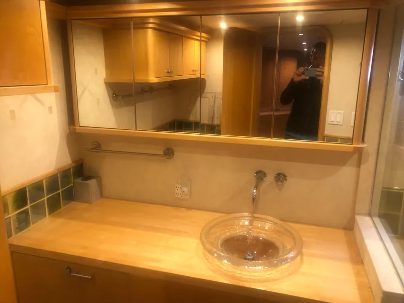 Slide: The Image of 2003 Cape Horn Trawler bathroom with wooden cabinetry and glass sink. - 32