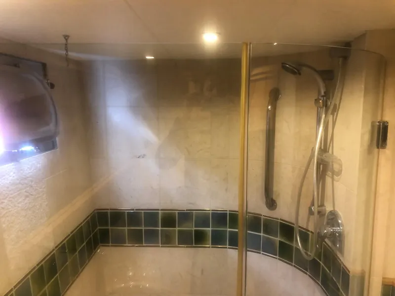 Slide: The Image of Shower area in 2003 Cape Horn Trawler with glass door and modern fixtures. - 34