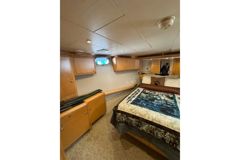 Slide: The Image of Cozy cabin interior of 2003 Cape Horn Trawler with bed and wooden storage cabinets. - 38