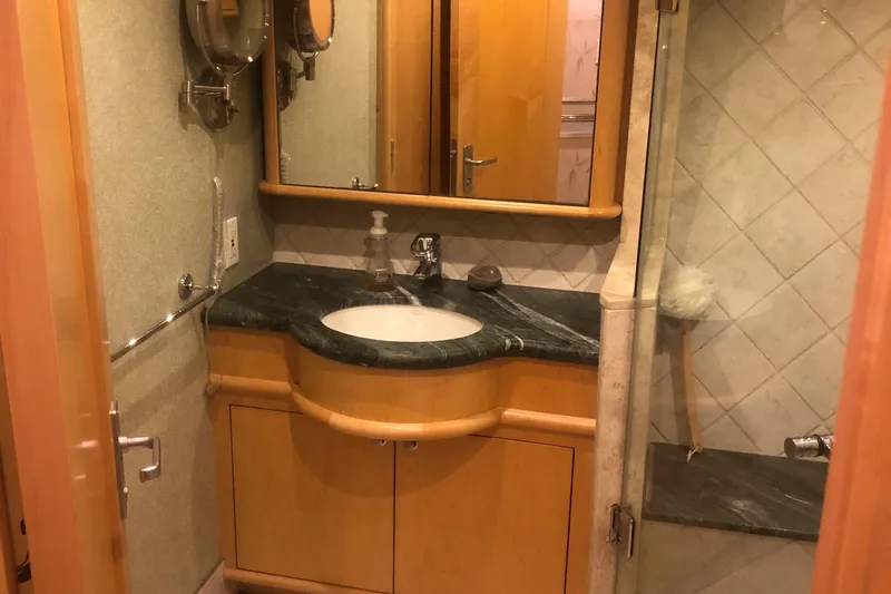 Slide: The Image of Bathroom interior of 2003 Cape Horn Trawler with wooden cabinetry and marble countertop. - 43