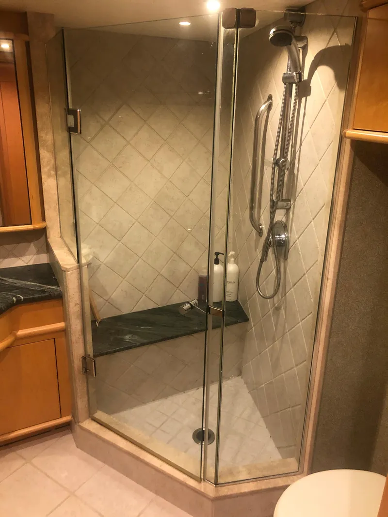 Slide: The Image of Luxurious shower in a 2003 Cape Horn Trawler, featuring glass doors and modern fixtures. - 44