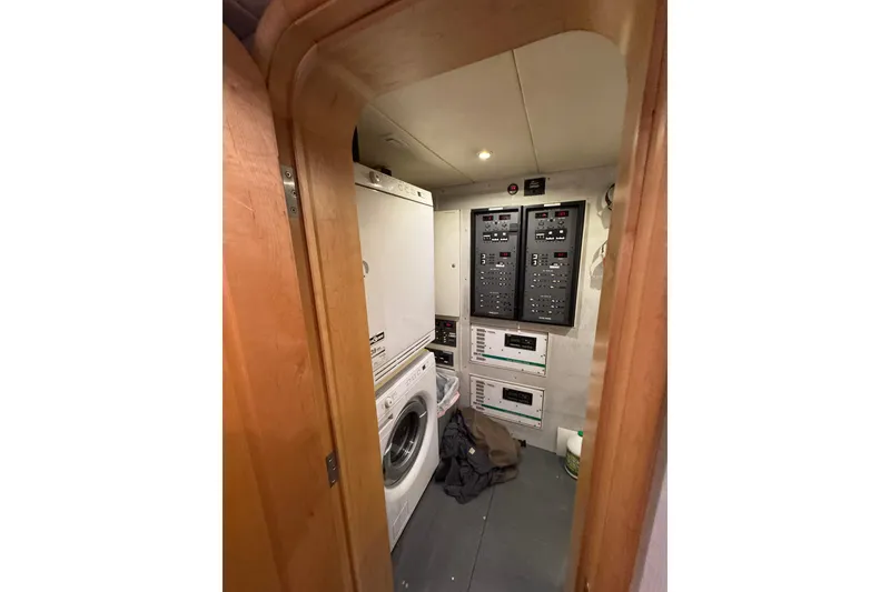 Slide: The Image of Laundry and control room inside 2003 Cape Horn Trawler, featuring washer and electrical panels. - 46