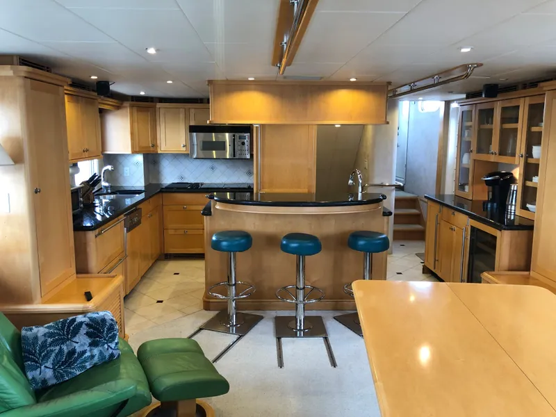 Slide: The Image of Luxurious 2003 Cape Horn Trawler interior with modern kitchen and bar stools. - 5
