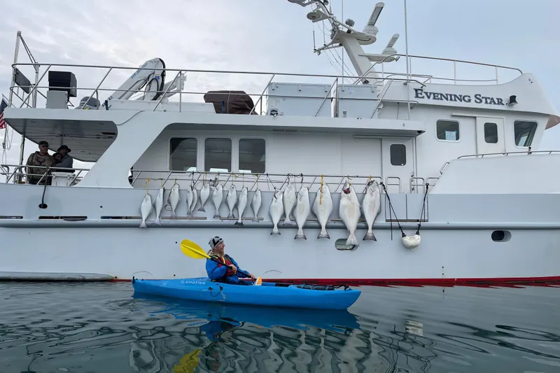 Slide: The Image of 2003 Cape Horn Trawler with fish catch, kayaker paddling nearby. - 56