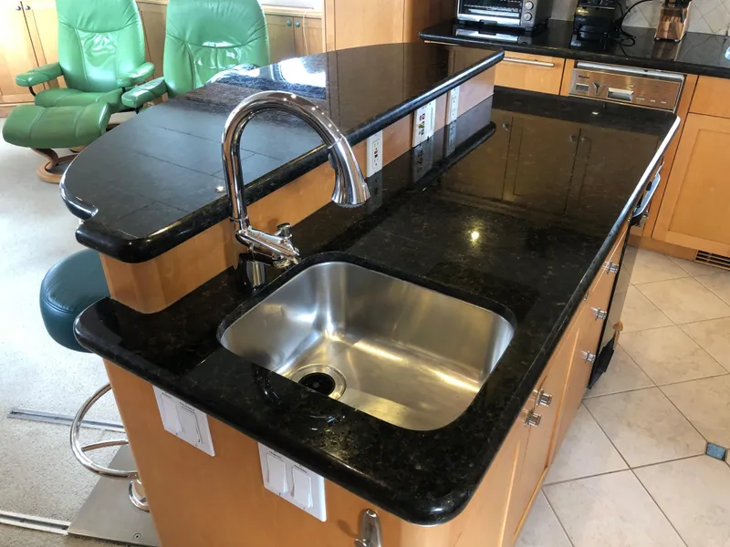 Slide: The Image of Luxurious kitchen interior of 2003 Cape Horn Trawler with granite countertops and stainless steel sink. - 8