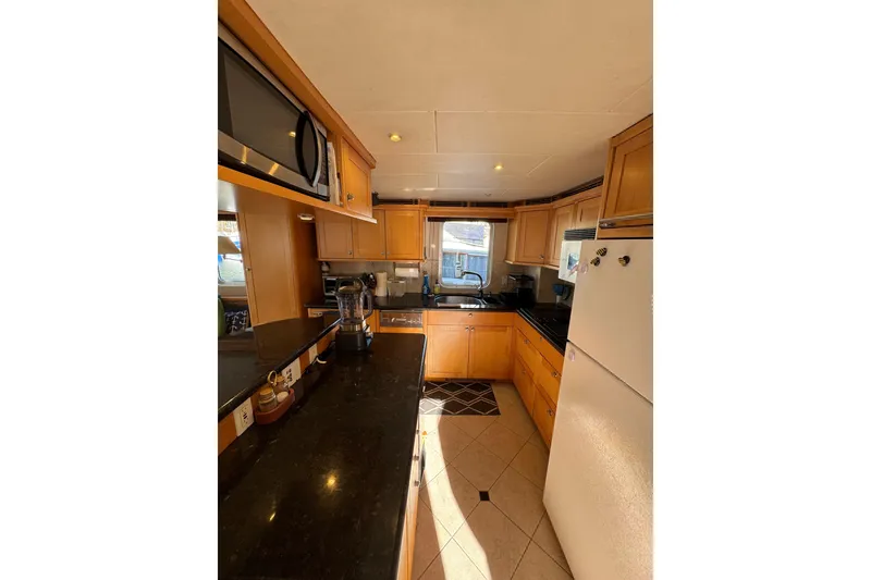 Slide: The Image of Kitchen interior of 2003 Cape Horn Trawler with modern appliances and wooden cabinetry. - 9
