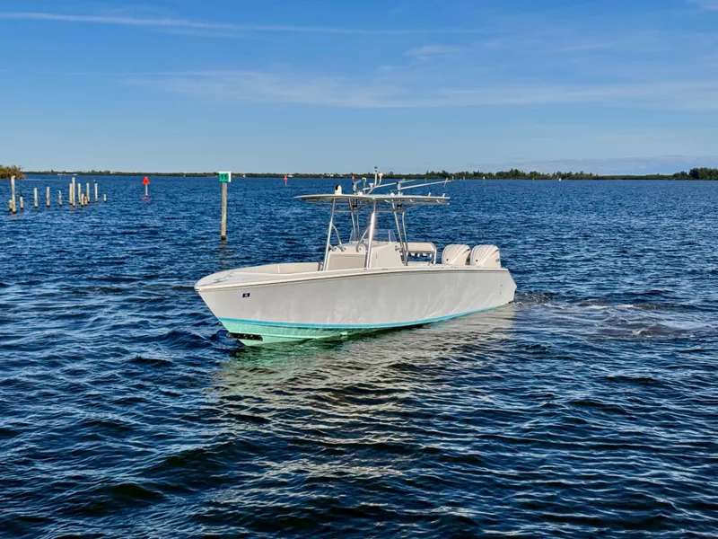 Slide: The Image of 2008 Jupiter 30 boat cruising on a calm blue sea under a clear sky. - 12