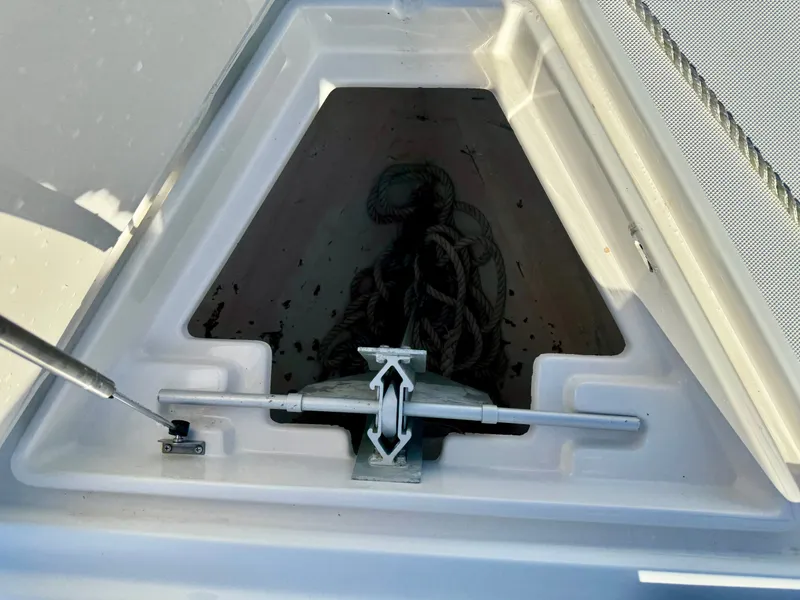Slide: The Image of Anchor storage compartment on a 2008 Jupiter 30 boat, featuring coiled rope. - 17