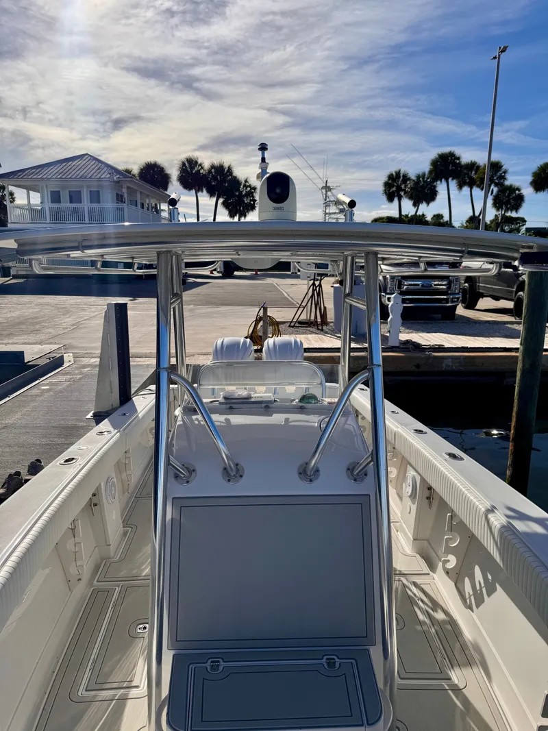 Slide: The Image of 2008 Jupiter 30 boat docked, featuring sleek design and modern equipment under a clear sky. - 18