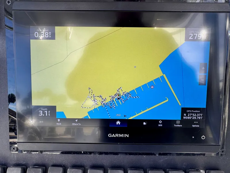 Slide: The Image of Garmin GPS display showing nautical map with depth and coordinates on a Jupiter 30, 2008 model. - 25