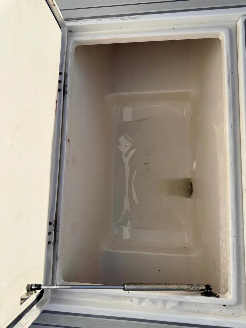 Slide: The Image of Open storage compartment on a 2008 Jupiter 30 boat, showing interior space. - 27