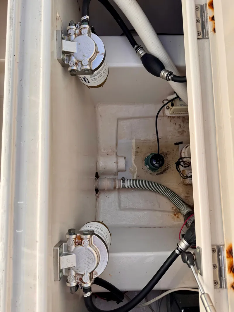 Slide: The Image of Engine compartment of a 2008 Jupiter 30 boat, showing filters and hoses. - 28