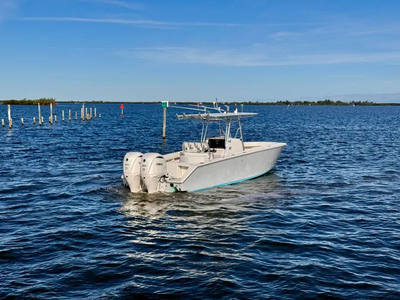 Slide: The Image of 2008 Jupiter 30 boat with twin Yamaha engines on open water. - 3