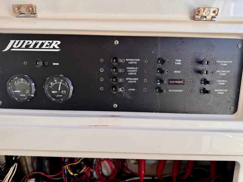 Slide: The Image of Control panel of a 2008 Jupiter 30 boat with switches and gauges. - 32