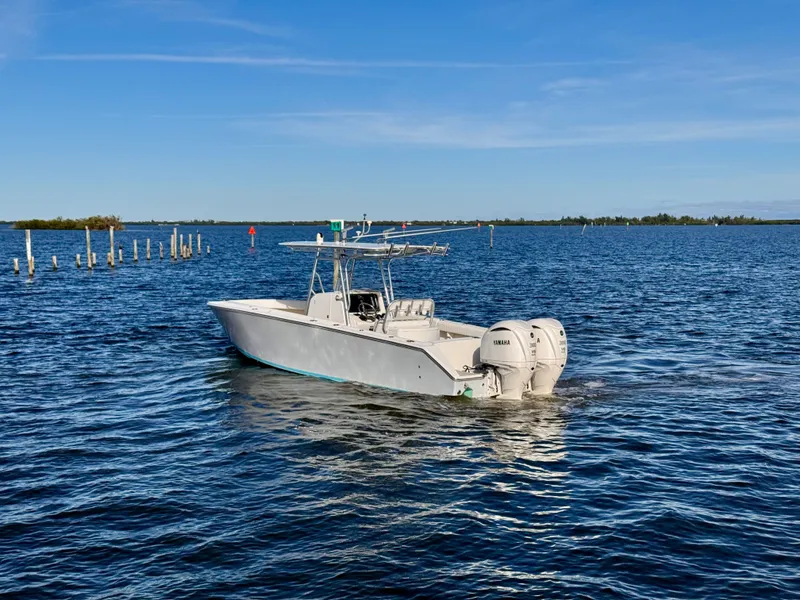 Slide: The Image of A 2008 Jupiter 30 boat with twin Yamaha engines on a calm blue sea. - 7