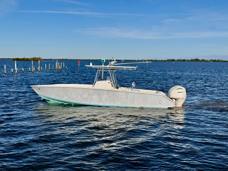 Slide: The Image of 2008 Jupiter 30 boat cruising on a calm blue sea under a clear sky. - 9