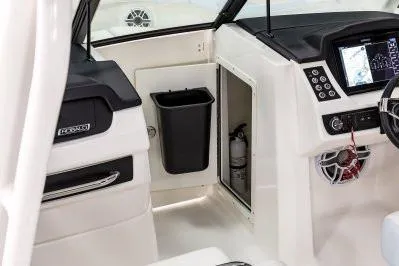 Slide: The Image of 2026 Robalo R257 Dual Console interior with control panel and storage. - 10