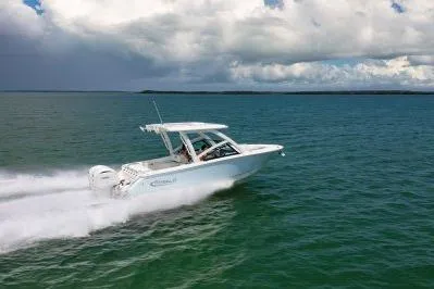 Slide: The Image of 2026 Robalo R257 Dual Console cruising on open water under cloudy skies. - 21