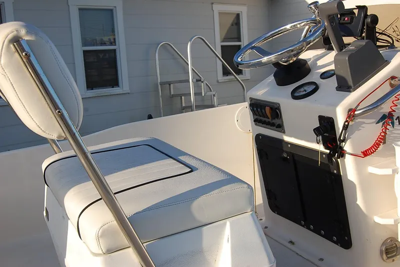 Slide: The Image of 2006 KEYWEST 152 boat interior with steering console and cushioned seating. - 10