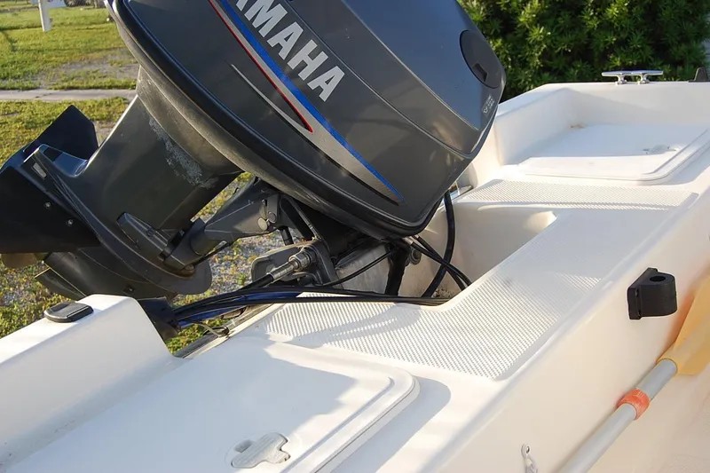 Slide: The Image of 2006 KEYWEST 152 boat with Yamaha outboard motor, white deck, and paddle. - 11