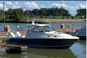 Slide: The Image of 2021 Pursuit OS 355 Offshore boat interior with seating and storage in a covered dock. - 1