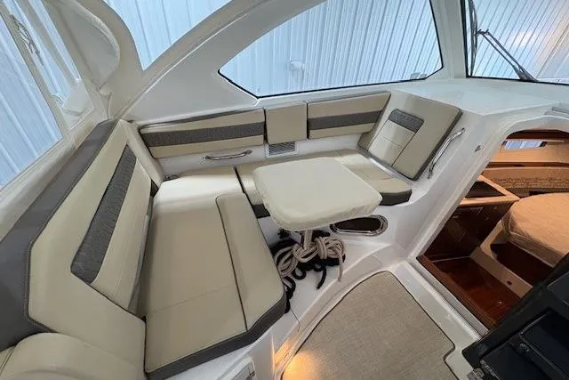 Slide: The Image of 2021 Pursuit OS 355 Offshore boat interior with helm, seating, and cabin view. - 17