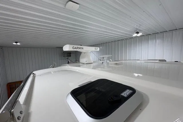 Slide: The Image of 2021 Pursuit OS 355 Offshore storage compartment with bucket and equipment. - 21