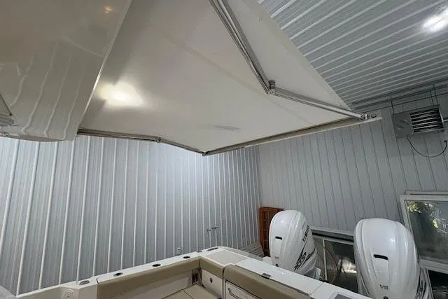 Slide: The Image of 2021 Pursuit OS 355 Offshore cabin interior with bed, stove, and microwave. - 24