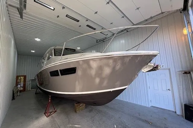 Slide: The Image of Manufacturer Provided Image: Luxurious interior of 2021 Pursuit OS 355 Offshore boat with elegant seating and wooden table. - 7