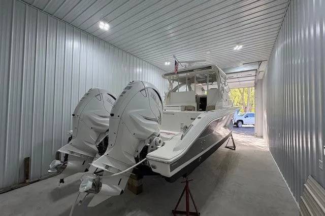 Slide: The Image of 2021 Pursuit OS 355 Offshore boat in storage, showcasing sleek design and modern features. - 9