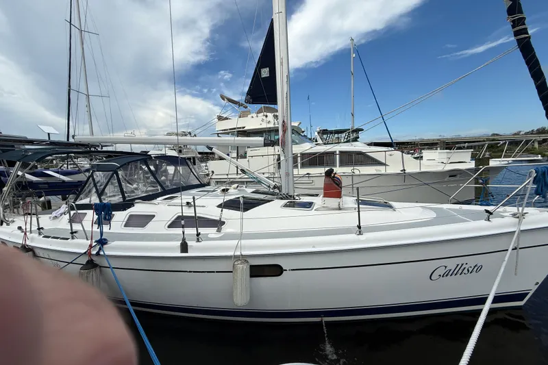 The Image of 2004 Hunter 386 sailboat named Callisto docked at a marina under a blue sky. - 0
