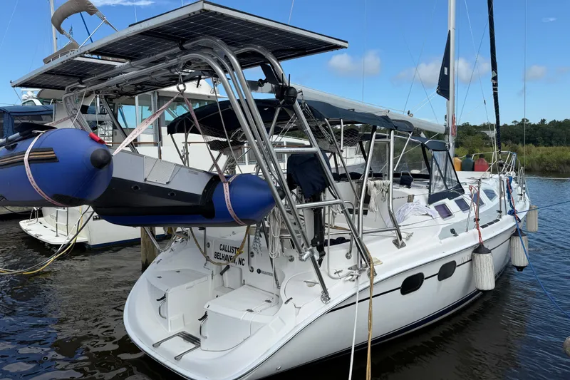 Slide: The Image of 2004 Hunter 386 sailboat docked with solar panels and inflatable dinghy. - 1