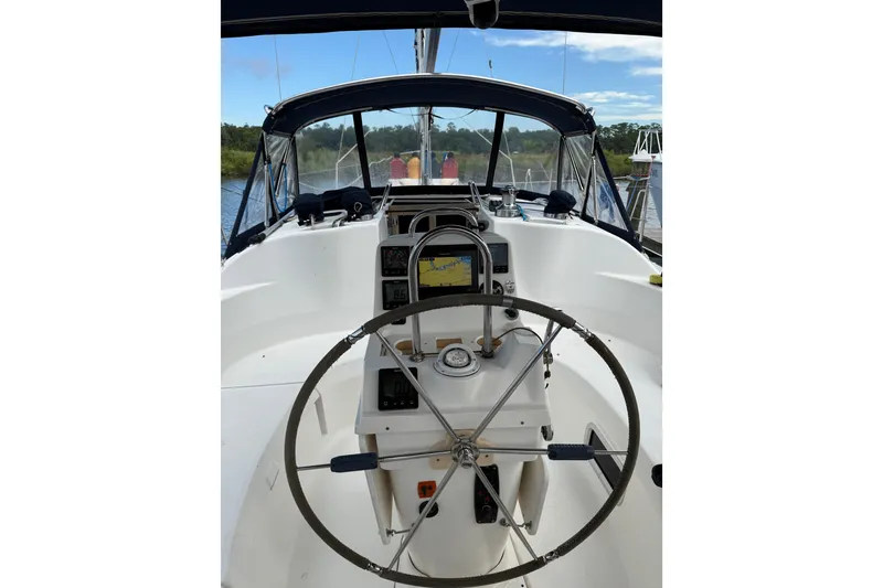 Slide: The Image of Interior view of 2004 Hunter 386 sailboat cockpit with steering wheel and navigation equipment. - 12