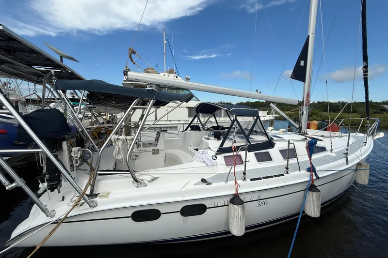 Slide: The Image of 2004 Hunter 386 sailboat docked at marina under clear blue sky. - 2