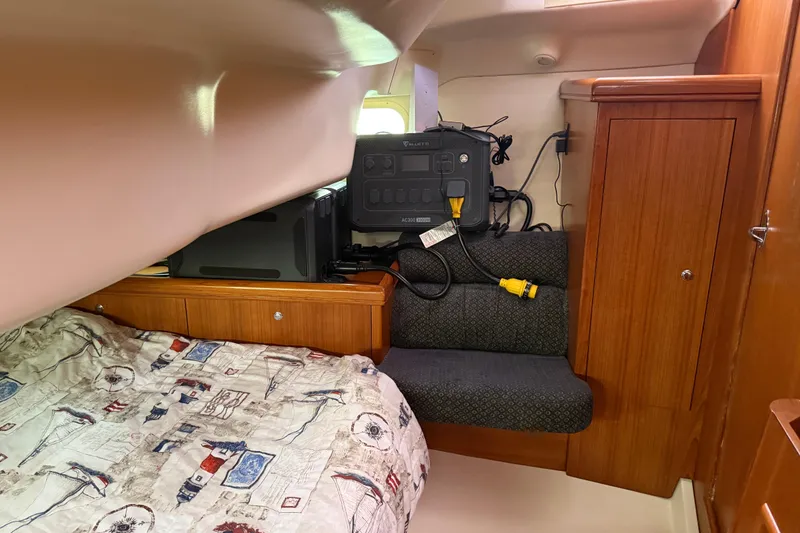 Slide: The Image of Cozy cabin interior of 2004 Hunter 386 sailboat with bed and storage. - 21